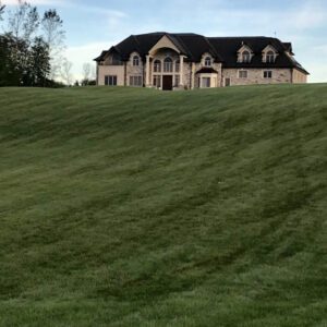 Large house and a freshly maintained lawn.